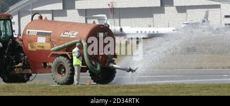 The runway is cooled at the Farnborough International Airshow in Hampshire. Stock Photo