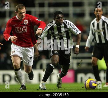 Newcastle United's Obafemi Martins (right) and Manchester United's Wayne Rooney in action during the Barclays Premiership match at St James Park, Newcastle. Stock Photo