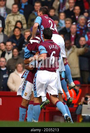 Aston Villa's John Carew celebrates scoring the opening goal with teammates Stock Photo