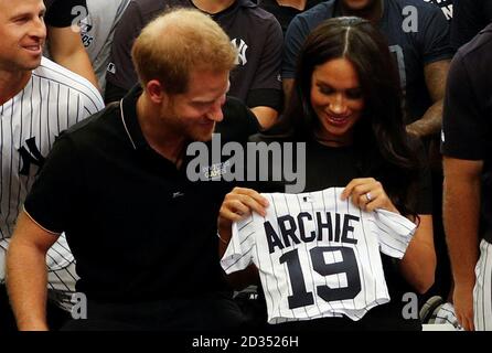 The Duke and Duchess of Sussex receive presents for their son Archie as they meet players of the New York Yankees as they attend the Boston Red Sox vs New York Yankees baseball game at the London Stadium in support of the Invictus Games Foundation. Stock Photo