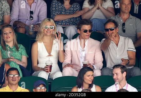 Pixie Lott and Oliver Cheshire in the stands on day eleven of the Wimbledon Championships at the All England Lawn tennis and Croquet Club, Wimbledon. Stock Photo