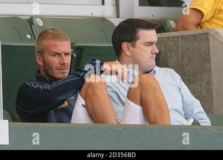 LA Galaxy's David Beckham sits with his Personal manager Terry Burn whilst his ankle is put in ice during a Friendly match at The Home Depot Center, Los Angeles, USA. Stock Photo