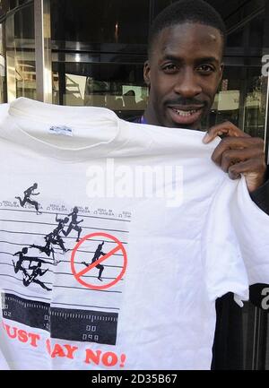 Dwain Chambers the GB and NI Team sprinter holds a T shirt, showing disgraced sprinter Ben Johnson winning his Olympic Gold medal, in Valencia, Spain. Chambers will compete in the 60m Race at the World Indoor Athletics Championships in the City. Stock Photo