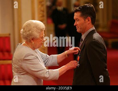 Graeme Hick receives his Member of the British Empire medal (MBE) from Queen Elizabeth II at an Investiture ceremony at Buckingham Place, London. Stock Photo