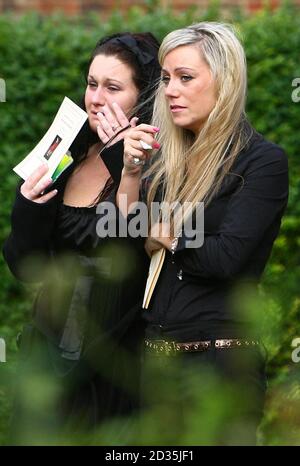 Kate Woolley (right), girlfriend of Guardsman Jamie Janes of the 1st Battalion Grenadier Guards, is accompanied by a friend as she watches his coffin leave St Philips Church in Hove, East Sussex, following his death in Afghanistan earlier this month. Stock Photo