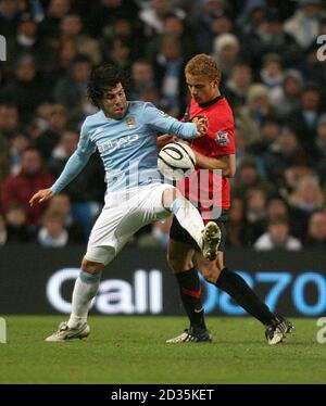 Manchester United's Wes Brown (left) gets away from Chelsea's Gustavo