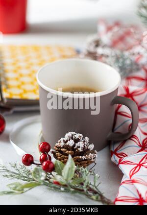 Cup of coffee, holiday decorations, cone and notebook, christmas planning concept. Happy new year. Stock Photo