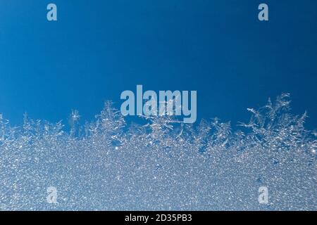 Abstract view of frost on window surface. Blue crystal frost texture. Cold winter background. Nobody Stock Photo