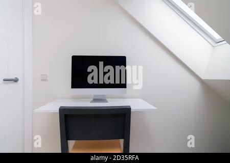 Computer with blank screen on the desk at home office. Working from home, isolation. Nobody Stock Photo