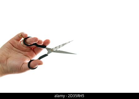 Close up of professional hairdresser holding scissors isolated on white background. Barber work tool - scissors on bright backdrop with space for text Stock Photo