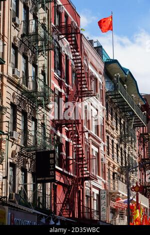 NEW YORK CITY, NY -27 SEP 2020- View of fire escapes emergency exits on the outside of old buildings in Chinatown, Manhattan, New York City. Stock Photo