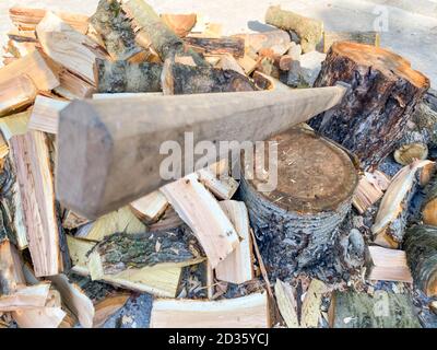 Ax stuck in a tree stump. Woodcutter's ax on the stump. Stock Photo