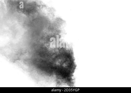 Black particles splatter on white background. Black powder dust burst. Stock Photo