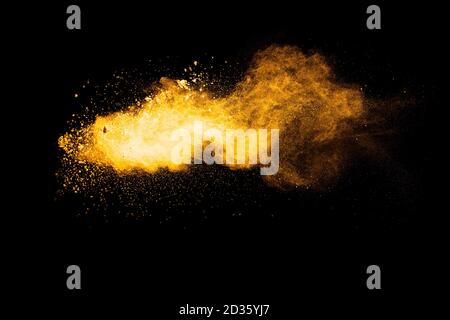 Orange color powder explosion on black background. Stock Photo