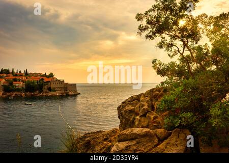 Sveti Stefan historical town island and resort at sunset. Budva riviera, Montenegro (Adriatic Sea), Europe. Travel concept, background. Stock Photo