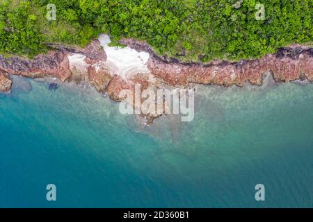 Aerial view of tiny rocky island in sea Stock Photo