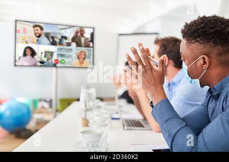 Business people in a video conference or during live streaming on monitor Stock Photo