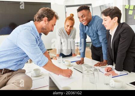 Young business people work together in a workshop or meeting Stock Photo