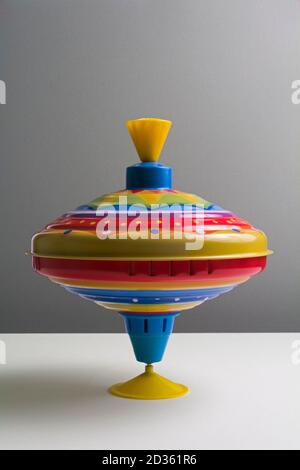 Spinning top on a gray. grey, background Stock Photo