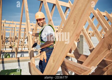 Construction worker wearing a helmet and holding a drill Stock Photo