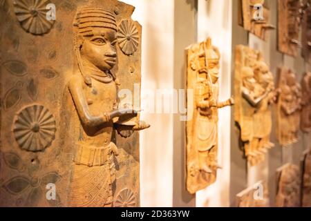 London. England. Benin Bronzes on display at the British Museum, brass plaques from the royal court palace of the Kingdom of Benin, 16-17th century Stock Photo