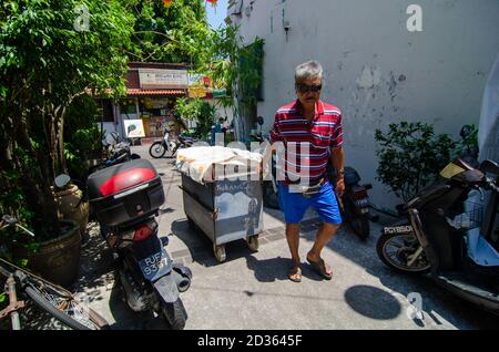 Georgetown, Penang/Malaysia - Feb 27 2020: A man repair show pull trolley at alley. Stock Photo