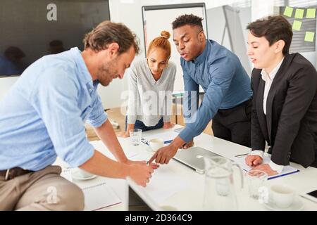 Start-up team at the conference table works together on project planning Stock Photo