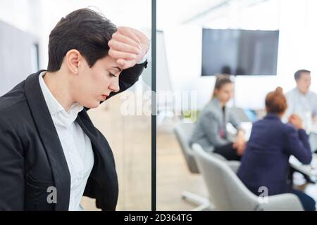 Tired business woman having a headache due to stress and overload in the office Stock Photo