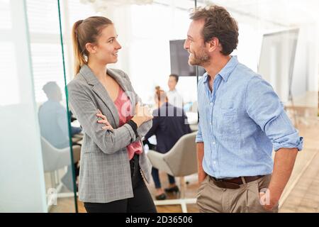Casual conversation between two business team colleagues in the office Stock Photo
