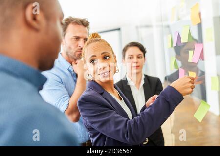 Young business woman and colleague having creative brainstorming with sticky notes Stock Photo