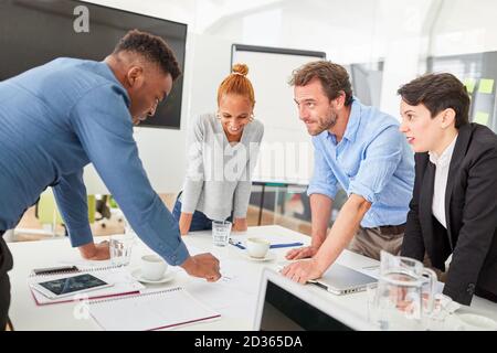 Group of young business people in a strategy workshop at the conference table Stock Photo