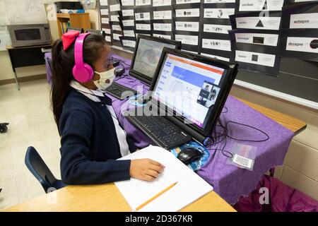 Austin, TX USA October 6, 2020: Third grade student Jasmine Saldivar uses a laptop to work on her lessons as she and her classmates return to in-person learning for the first time since March at Campbell Elementary in Austin. The public school is using a combination of remote and in-person learning in the age of coronavirus. Credit: Bob Daemmrich/Alamy Live News Stock Photo