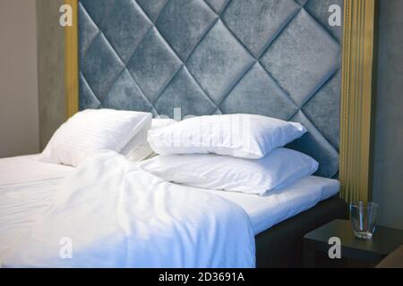 luxury messy bed with lot of pillows. rest, interior, comfort and bedding concept - bed at home bedroom Stock Photo