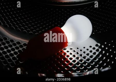 Lamp bulb on a metallic pattern Stock Photo