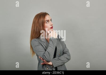 Hand on chin thinking about question, pensive expression. Doubt. Thoughtful face. Using that incredibly sharp business mind. Stock Photo