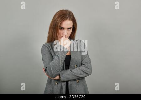 Attractive scowling angry, Head shot scowl, was offended gloomy eyebrows, Sulky, Waist-up portrait of beautiful face in displeasure, affront tensed, having bad mood, getting mad, frowning forehead Stock Photo