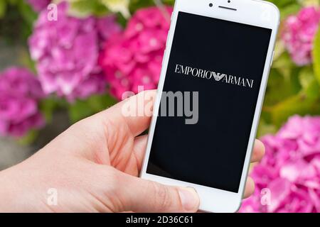 Guilherand-Granges, France - October 07, 2020. Person holding smartphone with Emporio Armani logo. Emporio Armani is an Italian fashion house and luxu Stock Photo