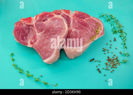 Raw fresh rib eye steaks and spice on the table. Meat ready for cooking. Stock Photo