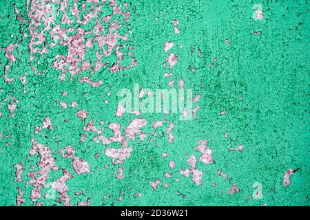 Background of old cracked green paint on cement wall. Stock Photo