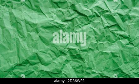 Crumpled green recycled paper, abstract background, copy space Stock Photo