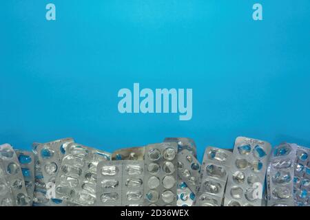 Empty blister packs without pills on blue background. Medical and healthcare concept. Copy space Stock Photo