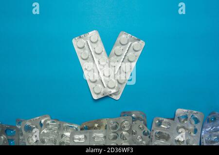 Blank blisters packs without pills and two packs of paracetamol tablets on blue background. Medical and healthcare concept. Top view Stock Photo