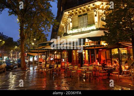 The famous cafe Les deux magots located on Saint-Germain boulevard .It was once home for to intellectual stars , from Hemingway to Picasso. Stock Photo