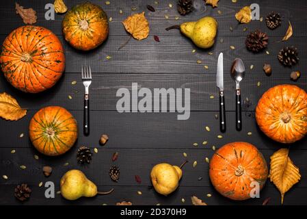 Autumn table setting with empty white plate and pumpkins. Stock Photo