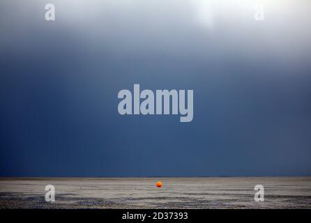 Heacham, UK. 06th Oct, 2020. A yellow marker buoy on the beach at low tide, with a grey sky behind it at Heacham, Norfolk, UK, on October 6, 2020. Credit: Paul Marriott/Alamy Live News Stock Photo