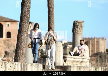 Rome, Italy. 6th Oct, 2020. People wearing face masks walk on Via dei Fori Imperiali in Rome, Italy, Oct. 6, 2020. Five southern regions of Italy have introduced mandatory mask laws, even for people in open spaces. And the government has announced that the national state of emergency, first put into place on Jan. 31, would be extended 'at least' until its one-year anniversary. Credit: Cheng Tingting/Xinhua/Alamy Live News Stock Photo