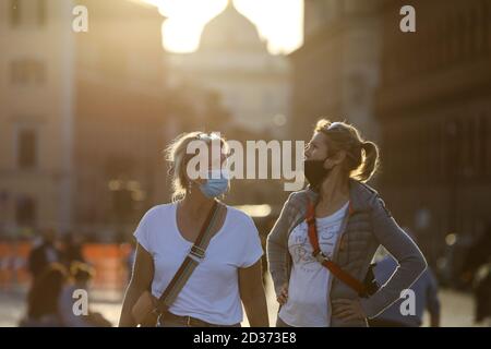 Rome, Italy. 6th Oct, 2020. People wearing face masks walk at Piazza Venezia in Rome, Italy, Oct. 6, 2020. Five southern regions of Italy have introduced mandatory mask laws, even for people in open spaces. And the government has announced that the national state of emergency, first put into place on Jan. 31, would be extended 'at least' until its one-year anniversary. Credit: Cheng Tingting/Xinhua/Alamy Live News Stock Photo