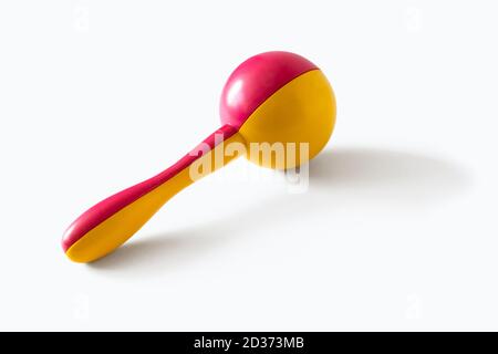 A pink and yellow shaker or maracas, isolated on a white background Stock Photo