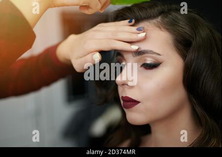 Hairdresser making new style for young woman in salon Stock Photo