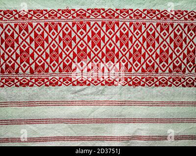 assamese gamosa ( gamusa , gamocha ) textile background ,gamusa pattern or gamosa border. gamosa is a traditional cloth of assam,north east. Stock Photo